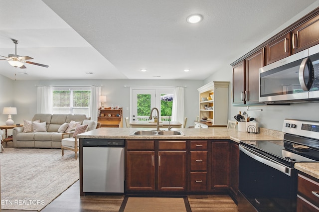406 Contentment Ln, Knoxville, TN 37920 - kitchen with appliances with stainless steel finishes, a sink, a peninsula, dark wood finished floors, and ceiling fan