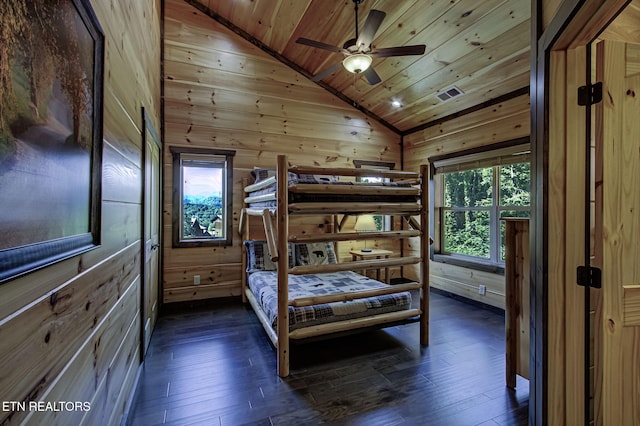 bedroom with wooden ceiling, lofted ceiling, wooden walls, and dark wood-type flooring