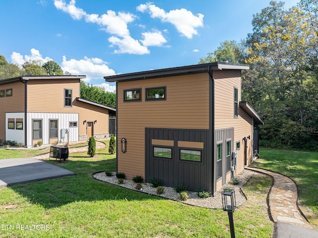 view of side of property featuring a yard and board and batten siding