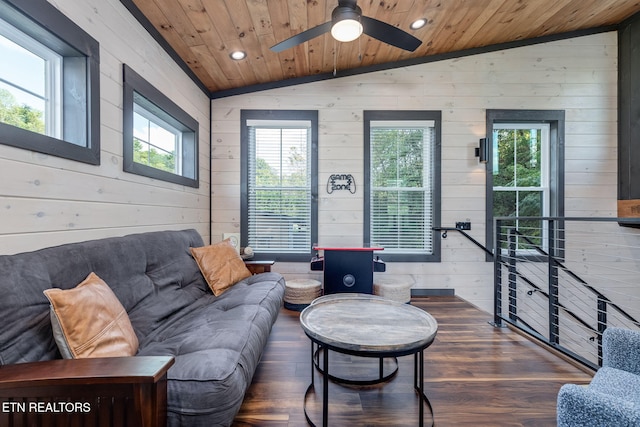 living room with lofted ceiling, plenty of natural light, wood ceiling, wooden walls, and wood finished floors