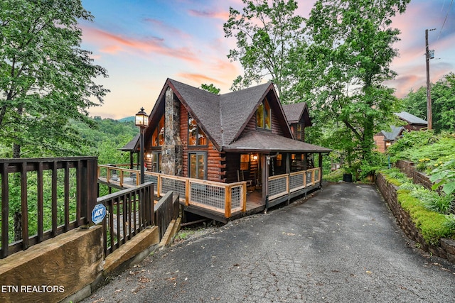 813 Pine Top Ln, Gatlinburg, TN 37738 - log-style house with log siding, a shingled roof, and a porch