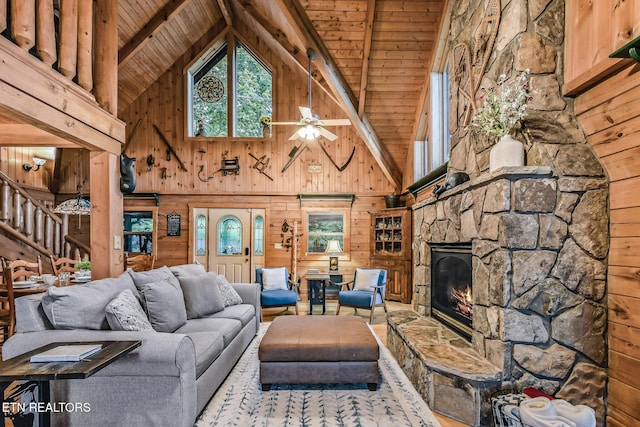 813 Pine Top Ln, Gatlinburg, TN 37738 - living room featuring high vaulted ceiling, wood ceiling with exposed beams, wooden walls, ceiling fan, and a fireplace