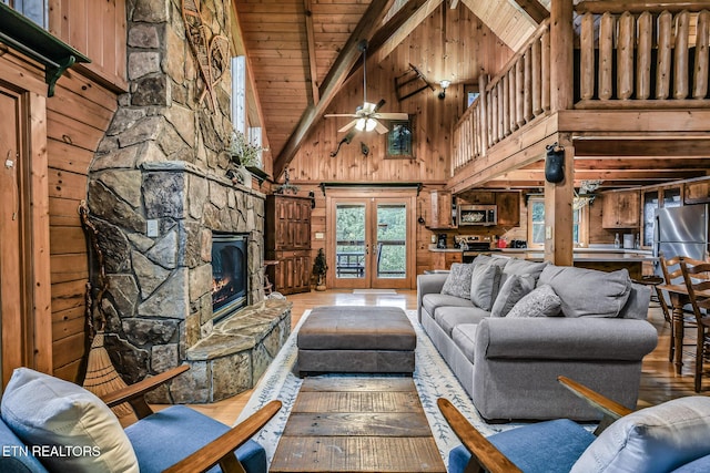 813 Pine Top Ln, Gatlinburg, TN 37738 - living area with high vaulted ceiling, hardwood / wood-style floors, wooden walls, wooden ceiling with exposed beams, and french doors