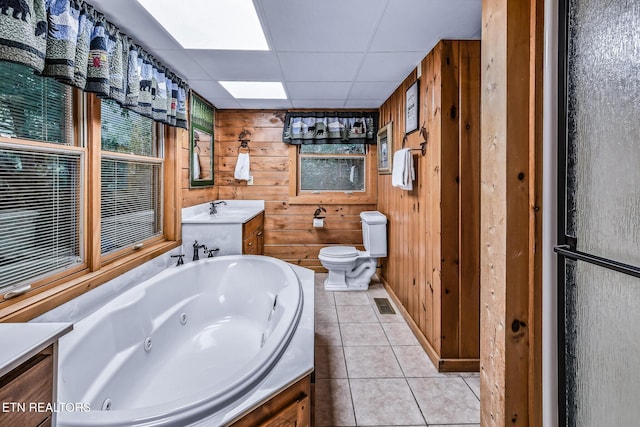 813 Pine Top Ln, Gatlinburg, TN 37738 - full bath with a jetted tub, tile patterned floors, toilet, vanity, and wood walls