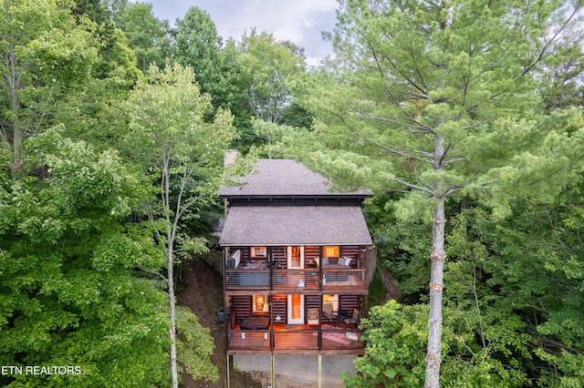 4186 Evans Chapel Rd, Sevierville, TN 37876 - view of front of house featuring a balcony, roof with shingles, a wooden deck, and a wooded view