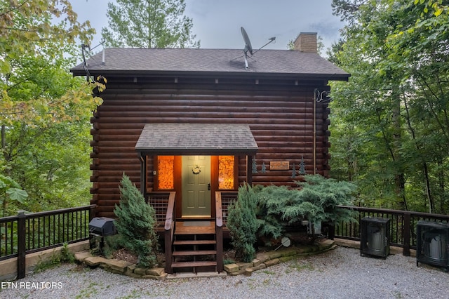 4186 Evans Chapel Rd, Sevierville, TN 37876 - view of front of home with log exterior, a shingled roof, and a chimney