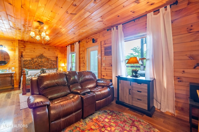 4186 Evans Chapel Rd, Sevierville, TN 37876 - living room featuring wooden walls, healthy amount of natural light, wood finished floors, and wooden ceiling