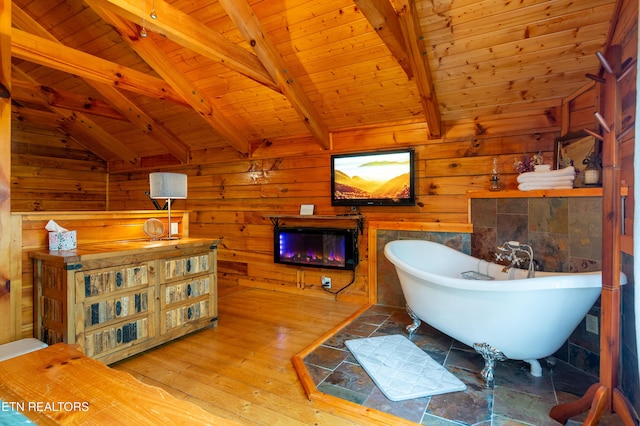 4186 Evans Chapel Rd, Sevierville, TN 37876 - full bath featuring wood ceiling, hardwood / wood-style flooring, a soaking tub, and wooden walls