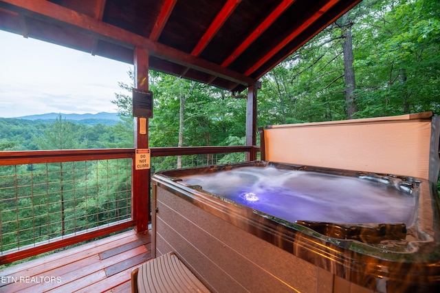 4186 Evans Chapel Rd, Sevierville, TN 37876 - wooden terrace with a hot tub, a mountain view, and a wooded view