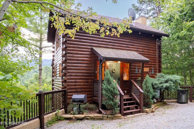 4186 Evans Chapel Rd, Sevierville, TN 37876 - cabin with log siding, a shingled roof, and a chimney