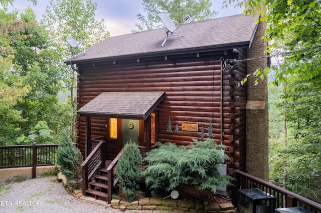 4186 Evans Chapel Rd, Sevierville, TN 37876 - view of front of house featuring log siding, roof with shingles, and stairway