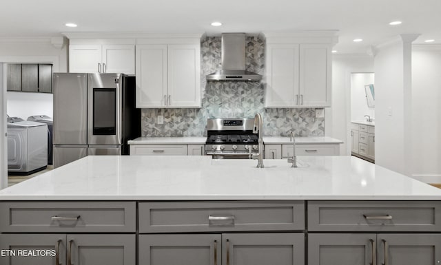 520 S David Ln, Knoxville, TN 37922 - kitchen featuring gray cabinets, washing machine and clothes dryer, wall chimney range hood, stainless steel appliances, and crown molding