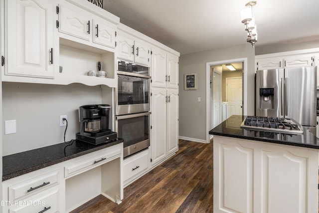 kitchen featuring appliances with stainless steel finishes, white cabinetry, dark wood-style flooring, open shelves, and dark stone counters