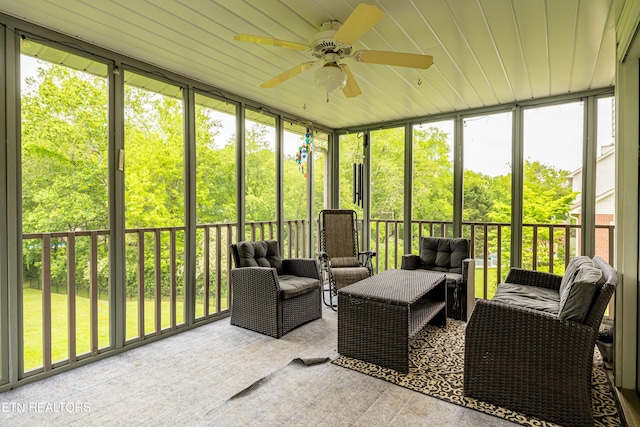 sunroom / solarium with ceiling fan and an outdoor living space