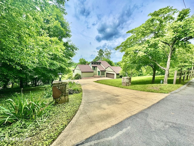 721 Fan St, Tazewell, TN 37879 - view of front of property featuring a front lawn, a garage, and concrete driveway