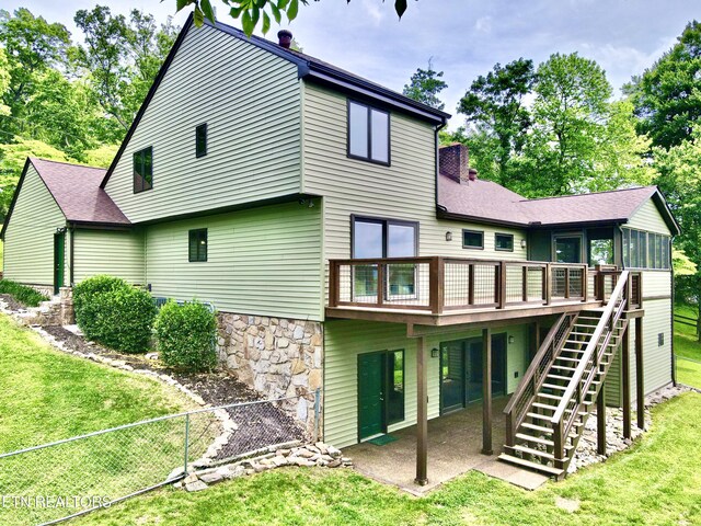 721 Fan St, Tazewell, TN 37879 - rear view of property featuring stairway, a sunroom, a chimney, a deck, and a patio area