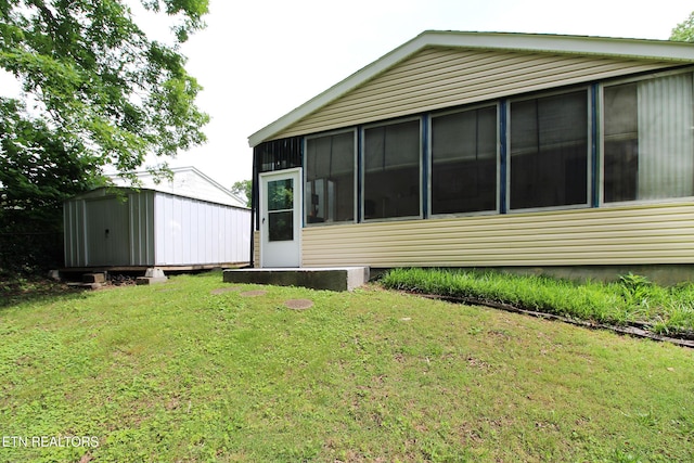 4708 Springbrook Rd, Knoxville, TN 37921 - view of property exterior with a storage unit, an outbuilding, a yard, and a sunroom