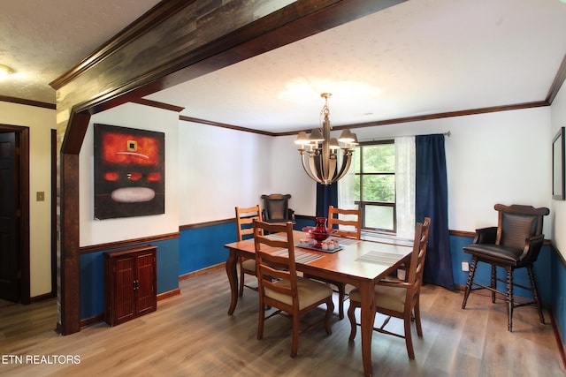 4708 Springbrook Rd, Knoxville, TN 37921 - dining space with a chandelier, wood finished floors, ornamental molding, baseboards, and a textured ceiling