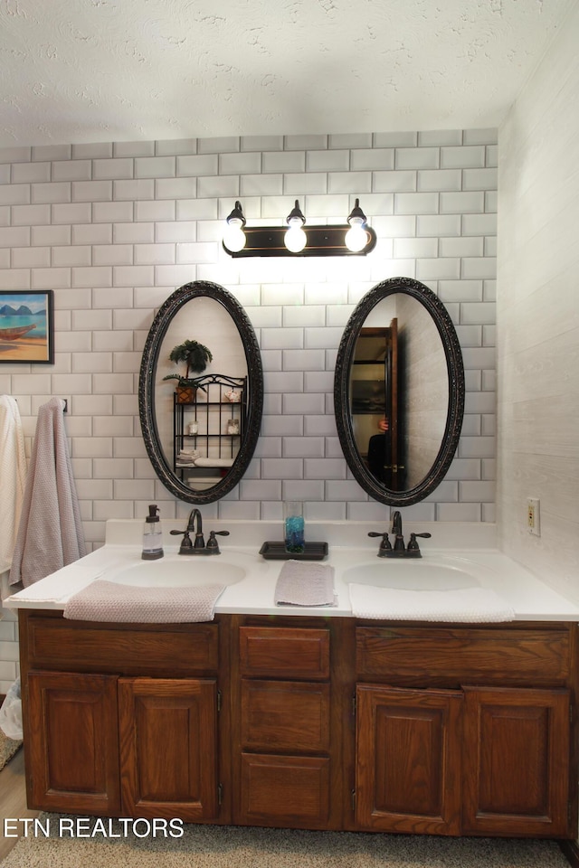 4708 Springbrook Rd, Knoxville, TN 37921 - bathroom featuring double vanity, a textured ceiling, and backsplash