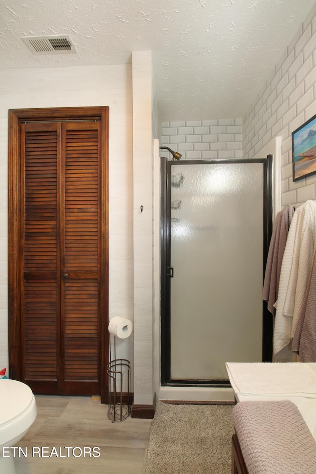 4708 Springbrook Rd, Knoxville, TN 37921 - full bathroom with wood finished floors, a shower stall, and a textured ceiling