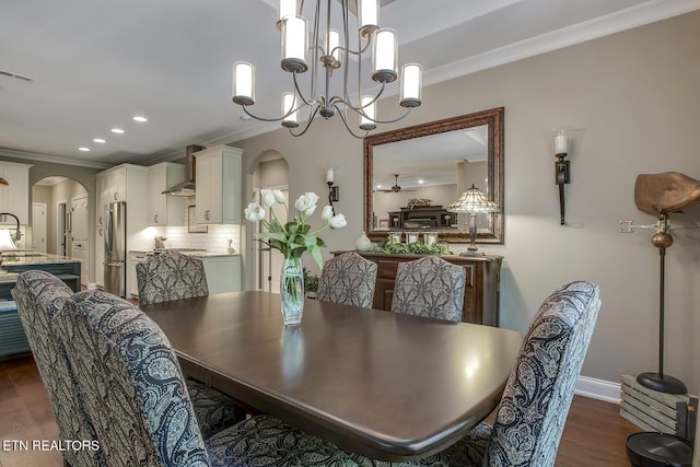 123 Seminole Ln, Loudon, TN 37774 - dining area featuring arched walkways, crown molding, dark wood-type flooring, recessed lighting, and a chandelier