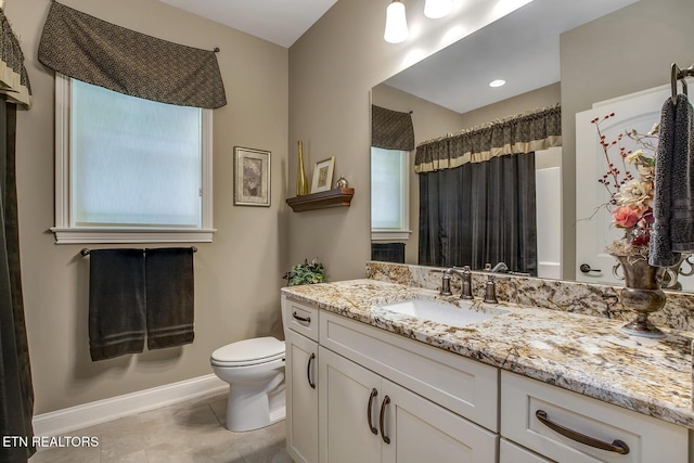 123 Seminole Ln, Loudon, TN 37774 - full bath featuring toilet, vanity, plenty of natural light, and baseboards