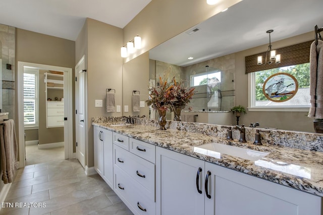 123 Seminole Ln, Loudon, TN 37774 - full bath with double vanity, a tile shower, a chandelier, tile patterned floors, and baseboards