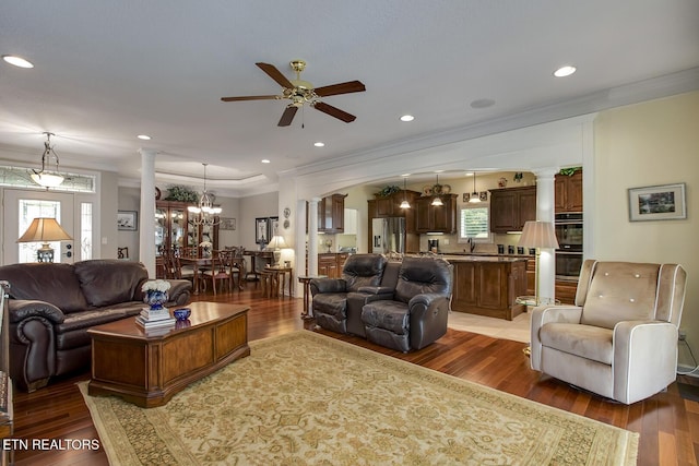 162 Tanasi Lagoon Dr, Loudon, TN 37774 - living room featuring decorative columns, ceiling fan, light wood-style flooring, ornamental molding, and a chandelier