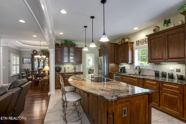 162 Tanasi Lagoon Dr, Loudon, TN 37774 - kitchen with stainless steel appliances, a sink, a center island, a breakfast bar area, and tasteful backsplash