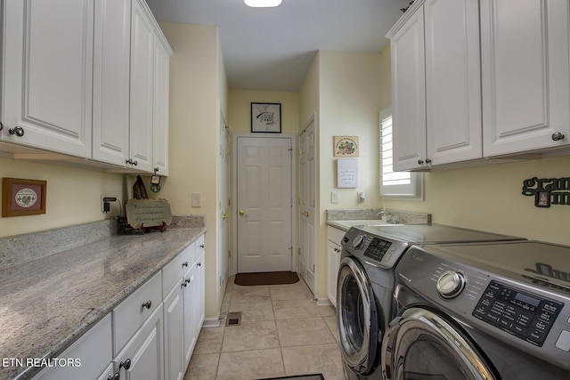 162 Tanasi Lagoon Dr, Loudon, TN 37774 - laundry area with washer and dryer, cabinet space, light tile patterned floors, and baseboards