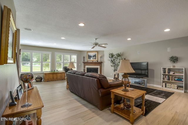 162 Tanasi Lagoon Dr, Loudon, TN 37774 - living room featuring light wood-style flooring, a fireplace, a ceiling fan, recessed lighting, and a textured ceiling