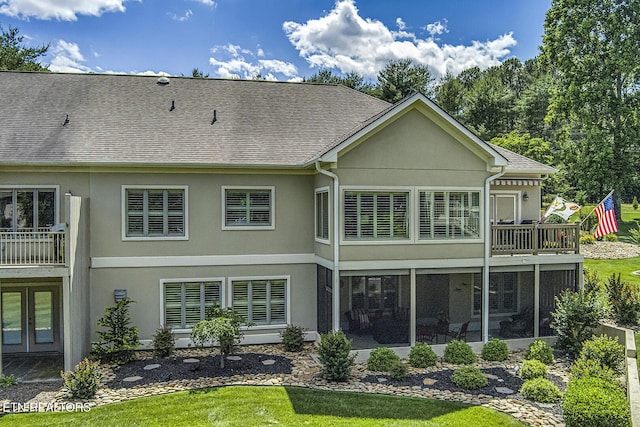 162 Tanasi Lagoon Dr, Loudon, TN 37774 - back of property with stucco siding, a sunroom, a shingled roof, and a yard