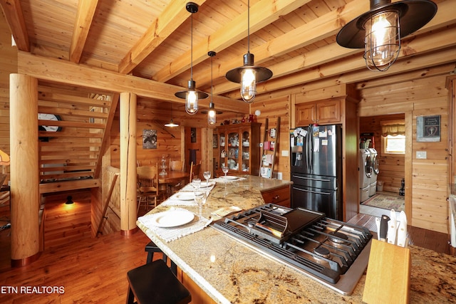 2266 Lone Ridge Dr, Sevierville, TN 37862 - kitchen with appliances with stainless steel finishes, separate washer and dryer, wooden walls, wood finished floors, and beamed ceiling