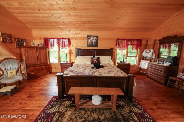 2266 Lone Ridge Dr, Sevierville, TN 37862 - bedroom featuring lofted ceiling, wood walls, dark wood-style flooring, and wood ceiling