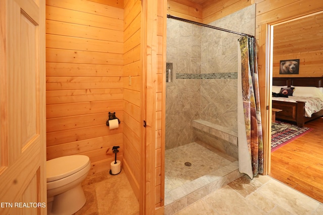 2266 Lone Ridge Dr, Sevierville, TN 37862 - bathroom with a stall shower, toilet, and wooden walls