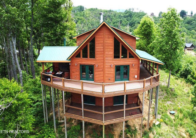 2266 Lone Ridge Dr, Sevierville, TN 37862 - back of house featuring french doors, log veneer siding, metal roof, and a wooden deck