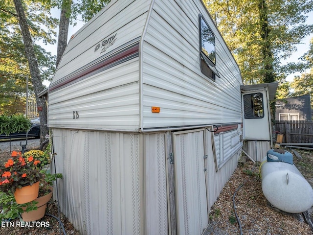 view of side of home featuring fence