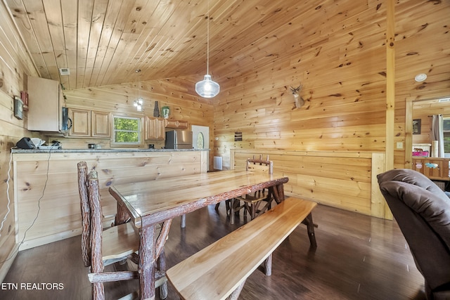 dining area featuring wood walls, vaulted ceiling, wooden ceiling, and dark wood finished floors