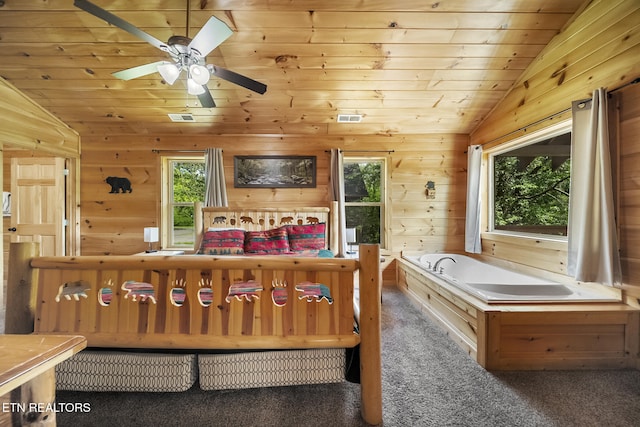 bedroom with vaulted ceiling, multiple windows, carpet flooring, wood ceiling, and wood walls