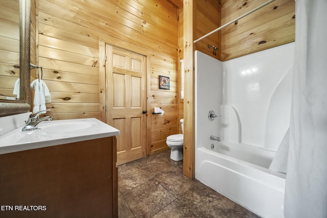full bath with toilet, wooden walls, shower / tub combo with curtain, and vanity