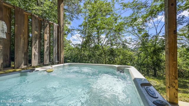 view of pool with a hot tub