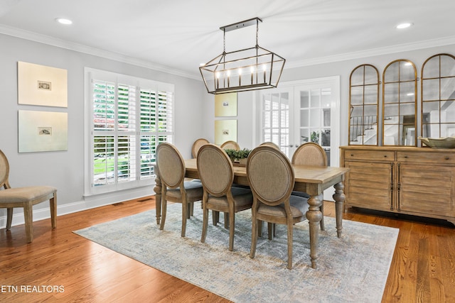 dining room featuring crown molding, baseboards, wood finished floors, a chandelier, and recessed lighting