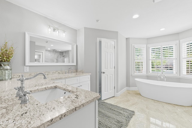 bathroom with a shower, a freestanding tub, double vanity, and recessed lighting