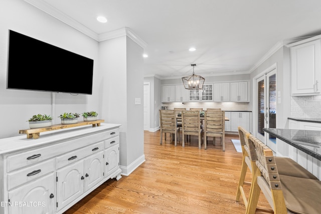 kitchen featuring a chandelier, white cabinetry, backsplash, recessed lighting, and light wood-style floors