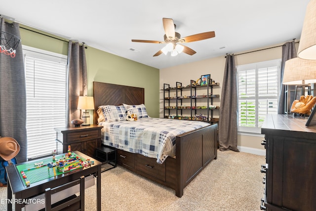 bedroom featuring baseboards, light carpet, and a ceiling fan