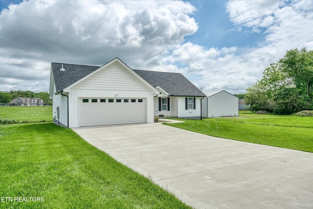 27 Jesse Loop, Crossville, TN 38555 - view of front of house featuring driveway, a front yard, an attached garage, roof with shingles, and board and batten siding