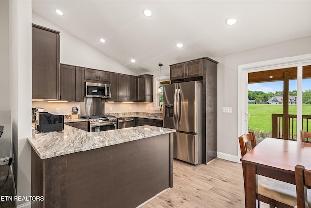 27 Jesse Loop, Crossville, TN 38555 - kitchen with stainless steel appliances, dark brown cabinetry, a peninsula, light wood finished floors, and light stone counters