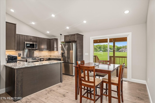 27 Jesse Loop, Crossville, TN 38555 - kitchen featuring appliances with stainless steel finishes, dark brown cabinetry, a peninsula, lofted ceiling, and light wood-style floors