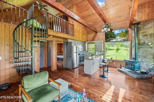 2892 N York Hwy, Pall Mall, TN 38577 - living room featuring ceiling fan, a wood stove, wooden walls, high vaulted ceiling, and beamed ceiling