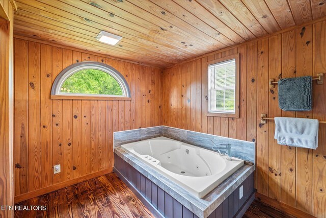 2892 N York Hwy, Pall Mall, TN 38577 - bathroom with wood ceiling, a whirlpool tub, wood finished floors, wood walls, and baseboards